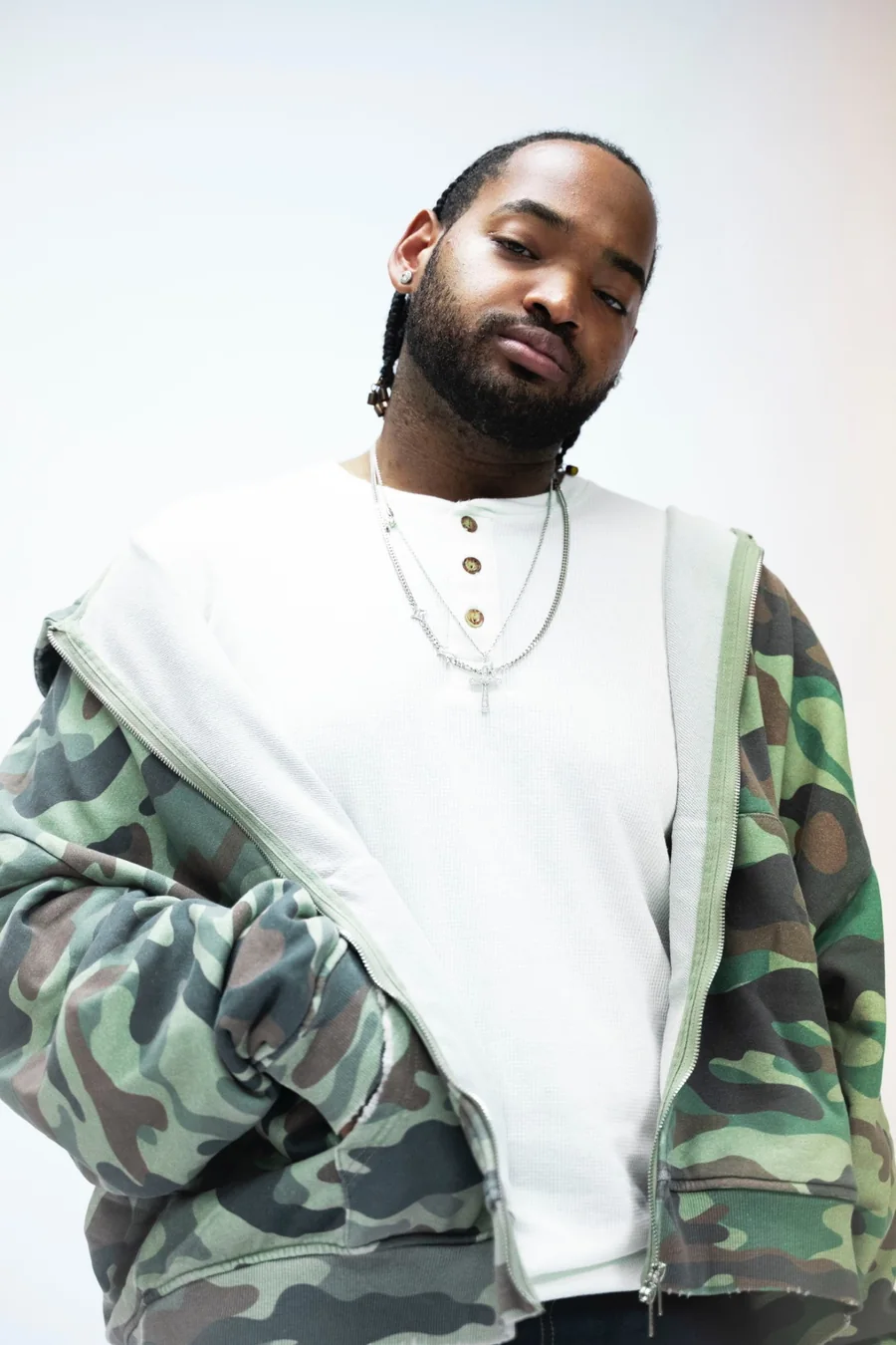 RaSean Parks portrait, camo zip jacket and white henley
